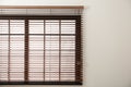 Modern window with stylish wooden blinds. Space for text Royalty Free Stock Photo