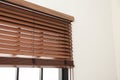 Modern window with stylish wooden blinds. Space for text Royalty Free Stock Photo