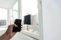 Modern window washer robot performs work on a dirty window. Cleaning the house with smart devices. Automatic window Royalty Free Stock Photo