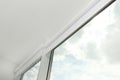 Modern window with white roller blinds, low angle view Royalty Free Stock Photo