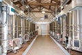 Modern winery interior with aluminium stainless steel wine vats in a row inside the winery