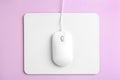 Modern wired optical mouse and pad on background, top view Royalty Free Stock Photo