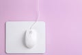 Modern wired optical mouse and pad on background, top view. Space for text Royalty Free Stock Photo