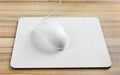 Modern wired optical mouse and pad on table Royalty Free Stock Photo