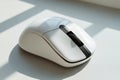 Modern wireless computer mouse on a bright desk with natural light Royalty Free Stock Photo