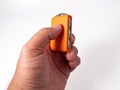 Modern wireless orange ignition key in hand on a white background. Royalty Free Stock Photo