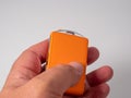 Modern wireless orange ignition key in hand on a white background. Royalty Free Stock Photo