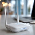 Modern wireless router with antennas on white desk in bright office setting Royalty Free Stock Photo