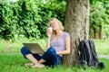 Modern woman with computer outdoor. Pretty woman drinking takeaway coffee. summer online. Morning chart. girl work on Royalty Free Stock Photo