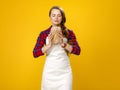 Modern woman farmer on yellow background enjoying fresh bread