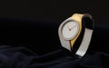 Modern woman gold and silver Wristwatch on dark velvet fabric background