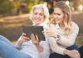 Modern woman spending picnic with old mother in the park