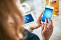 modern woman uses mobile devices in the kitchen Royalty Free Stock Photo