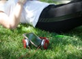 Modern woman, wireless headphones and smartphone on the grass Royalty Free Stock Photo