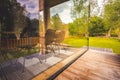 Modern wood house with patio and functional outdoor furniture with garden. Royalty Free Stock Photo