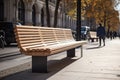 Modern wooden benches standing on the sides of the paved paths of the city park on a rainy day Royalty Free Stock Photo