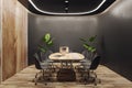 Modern wooden and black meeting room interior with equipment, furniture and decorative plants. Commercial workspace concept. 3D