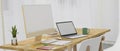 Modern wooden computer desk with yellow computer, laptop, stylus tablet blank screen mockup Royalty Free Stock Photo