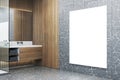 Modern wooden and concrete bathroom interior with empty white mock up banner on wall. Hotel interior designs concept. Royalty Free Stock Photo