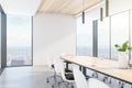 Modern wooden and concrete meeting room interior with empty white mock up place on wall, panoramic city view, daylight and large Royalty Free Stock Photo