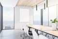 Modern wooden and concrete meeting room interior with empty white mock up poster on wall, panoramic city view, daylight and large Royalty Free Stock Photo