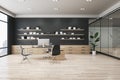 Modern wooden and concrete office interior with furniture, bookshelves with books, window with city view and daylight. Work and