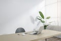 Modern wooden and concrete office interior with mock up place, workplace desk, laptop, chair, decorative plant, blinds and Royalty Free Stock Photo