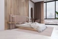 Modern wooden and concrete stylish hotel bedroom interior with window and city view. Design concept. Royalty Free Stock Photo