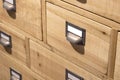 Modern wooden drawers boxes filing cabinet with blank mockup metal file labels tags with copy space