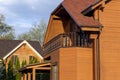 Modern wooden eco house villa facade luxury big house. Timber cottage with with green lawn water sprinkler, paved