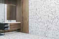 Modern wooden and marble tile bathroom interior with empty mock up place on wall and mirror. Royalty Free Stock Photo