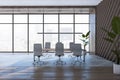 Modern wooden meeting room interior with panoramic window and city view, furniture and decorative plant. Office designs concept. Royalty Free Stock Photo