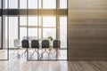 Modern wooden meeting room office interior with empty mock up place on wall, table, armchairs, window with city view and daylight Royalty Free Stock Photo