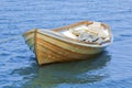 Modern wooden small fishing boat in blue water, closeup Royalty Free Stock Photo