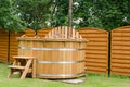 Modern wooden water hot tub with stairs outdoor Royalty Free Stock Photo