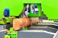 A modern woodworking sawmill quickly and accurately automatically cuts a log, close-up