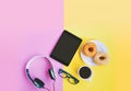 Modern work space, Black coffee and donuts, eye glasses, headphone with tablet on pastel background with copy space Royalty Free Stock Photo