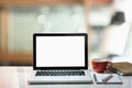 Modern work space, laptop with white screen, coffee cup and note book. Royalty Free Stock Photo