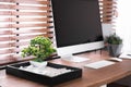 Modern workplace with beautiful miniature zen garden and computer