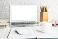 Modern workplace with empty white laptop display Royalty Free Stock Photo