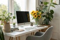 Modern workplace with computer, houseplants, and sunflowers Royalty Free Stock Photo
