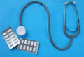 Close up Stethoscope and pill isolate on blue background .Copy space Medical and health concept