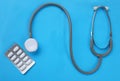 Close up Stethoscope and pill isolate on blue background .Copy space Medical and health concept