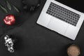 Modern workplace with a laptop keyboard, cup of coffee, red apple, photo camera and headphones on a dark office desk background Royalty Free Stock Photo