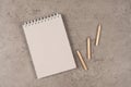 Modern workplace with recycled paper spiral blank notebook and wood pencils on gray desk background. Top view Royalty Free Stock Photo