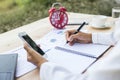 Modern workplace woman using mobile phone sitting at wooden table in office Royalty Free Stock Photo