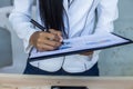 Modern workplace woman using mobile phone sitting at wooden table in office Royalty Free Stock Photo