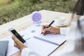 Modern workplace woman using mobile phone sitting at wooden table in office Royalty Free Stock Photo