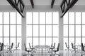 Modern workplaces in a modern bright clean interior of a loft style office. Huge windows with copy space and white walls. White de Royalty Free Stock Photo