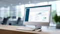 Modern workspace with desktop computer displaying data analytics dashboard and graphs on screen with keyboard and mouse on wooden Royalty Free Stock Photo